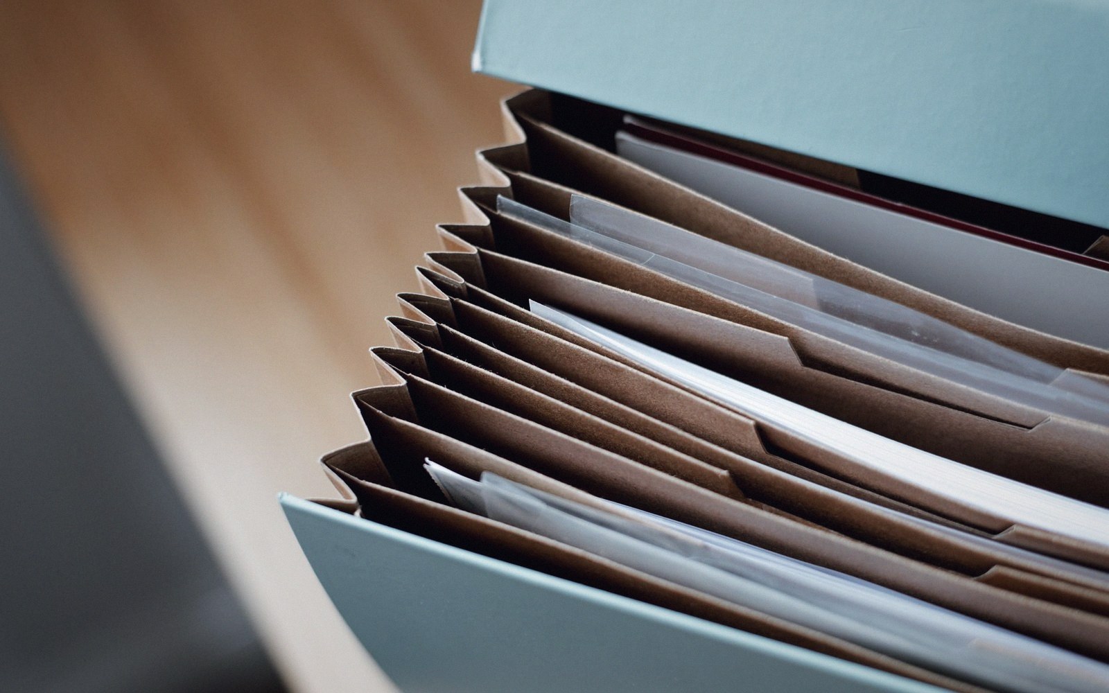 An open filing drawer of numbered folders